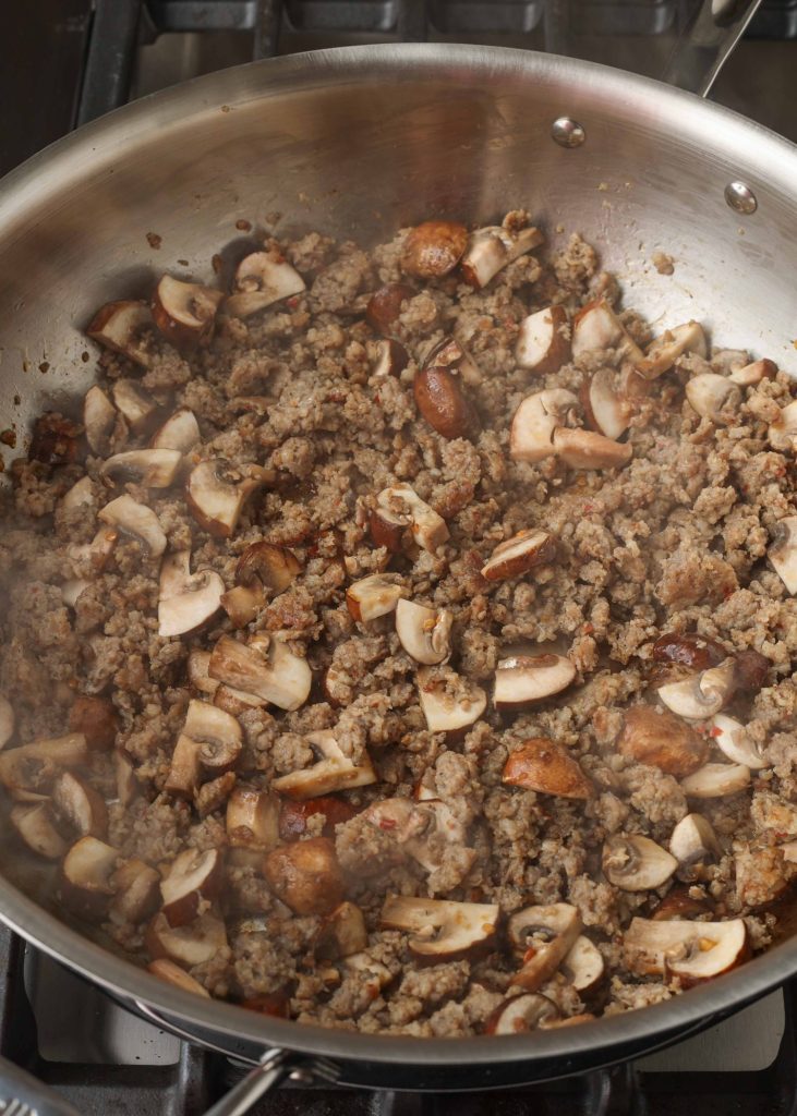 mushrooms and sausage in skillet
