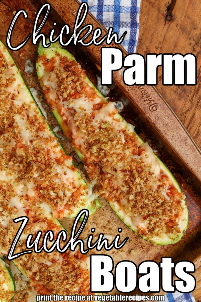 chicken parmesan zucchini boats with gooey mozzarella cheese and toasted breadcrumbs lie side by side on a copper sheet pan