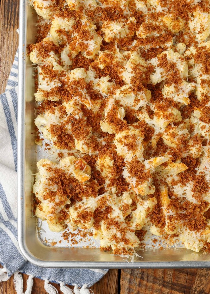 toasted bread crumbs and freshly shredded parmesan cheese have been added to the roasted cauliflower for finishing in the oven