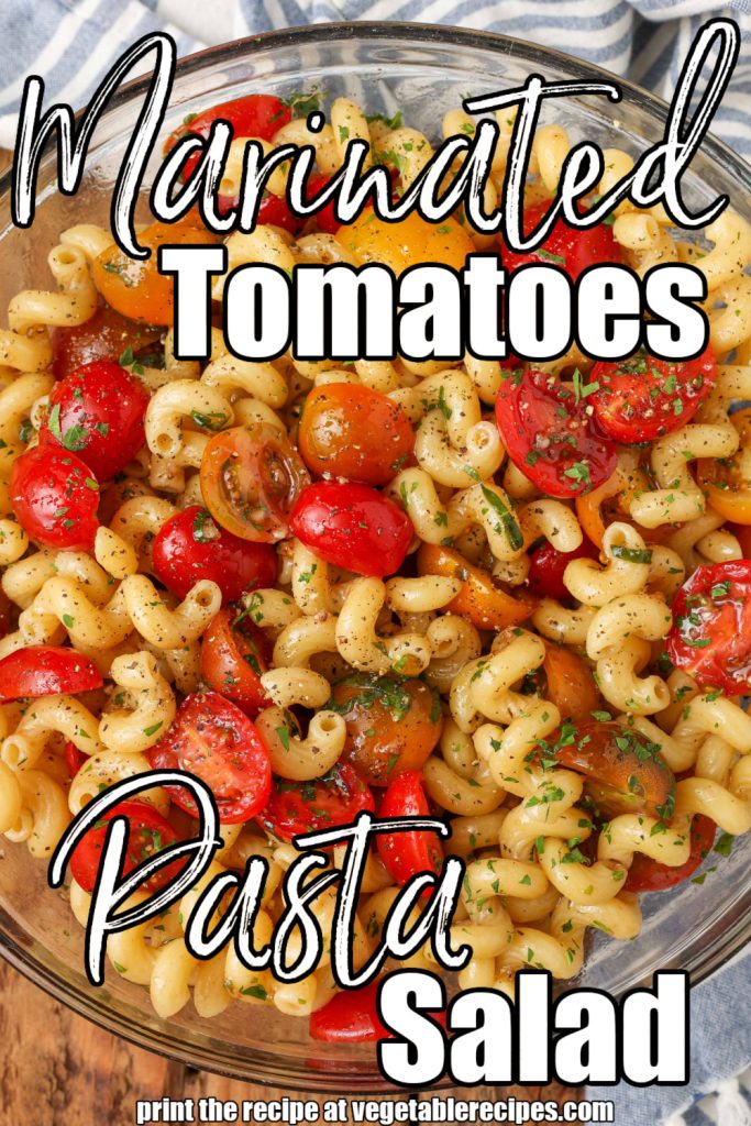 white lettering is overlaid this image of a glass bowl full of pasta salad and tomatoes. It reads, "Marinated Tomatoes Pasta Salad"