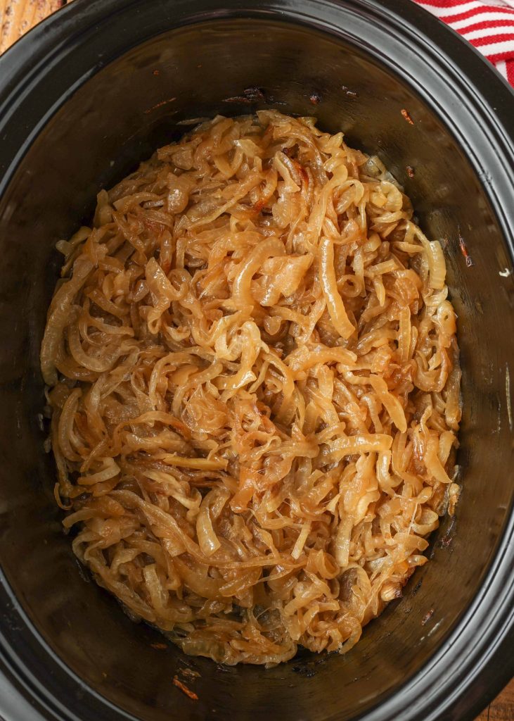 a top down photo of finished caramelized onions in the slow cooker
