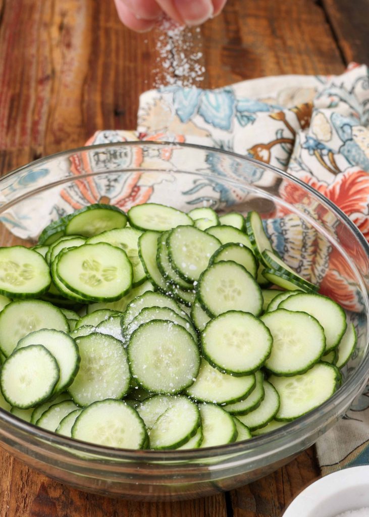 cucumbers in glass bowl sprinkled with salt