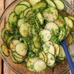 cucumber salad in bowl with sesame seeds and green onions