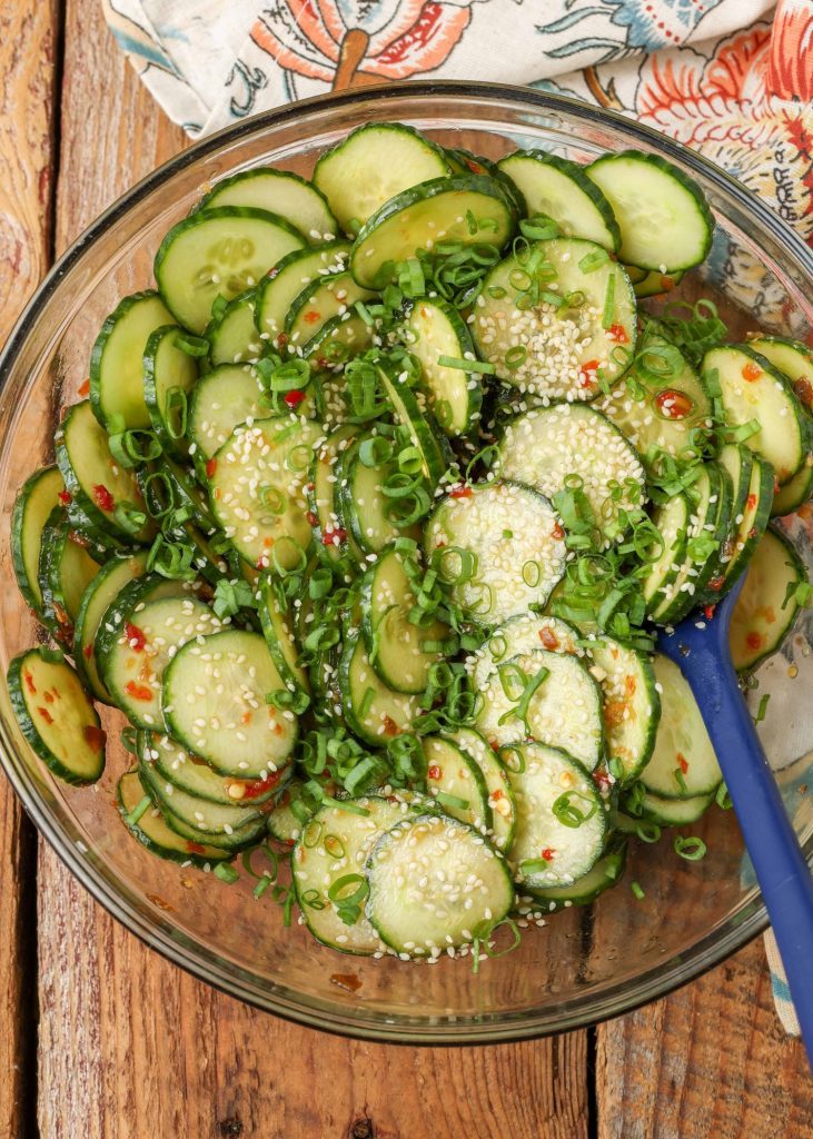 cucumber salad in bowl with sesame seeds and green onions
