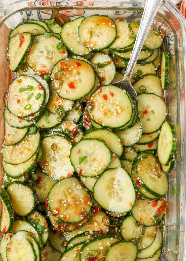 Spicy Asian Cucumber Salad in glass dish with silver spoon