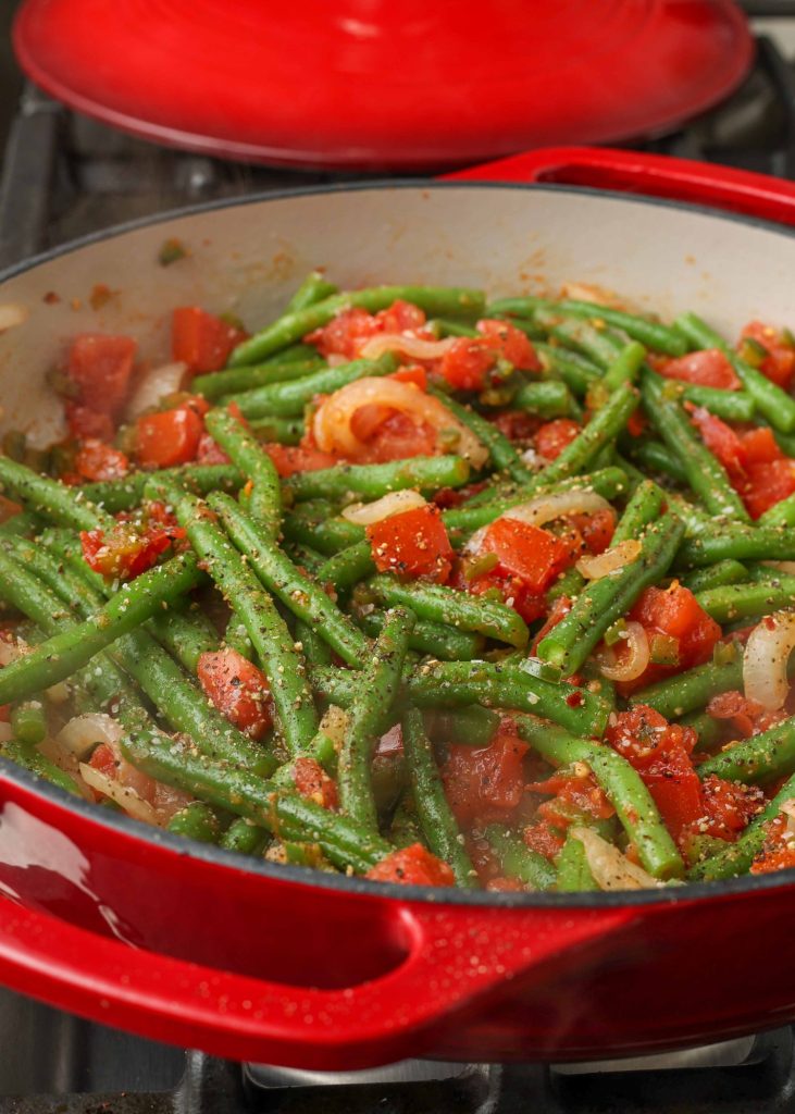 spicy green beans in red skillet