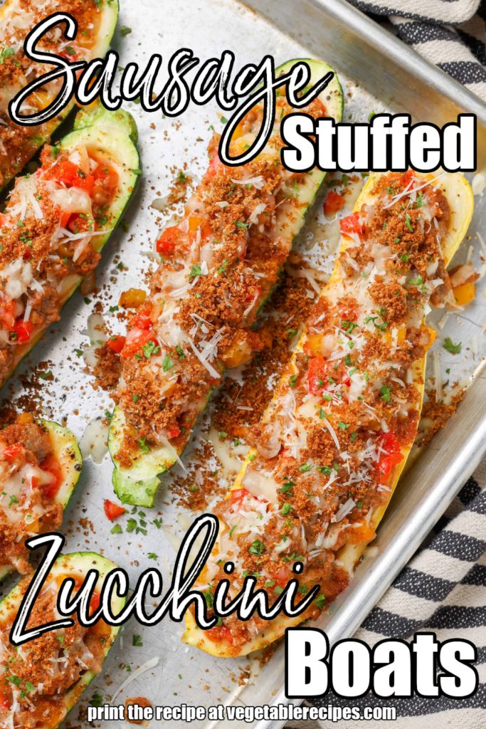 Overhead shot of zucchini stuffed with sausage, bell peppers, and cheese in a long baking sheet