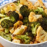 close up of broccoli and cauliflower in white bowl with blue cloth