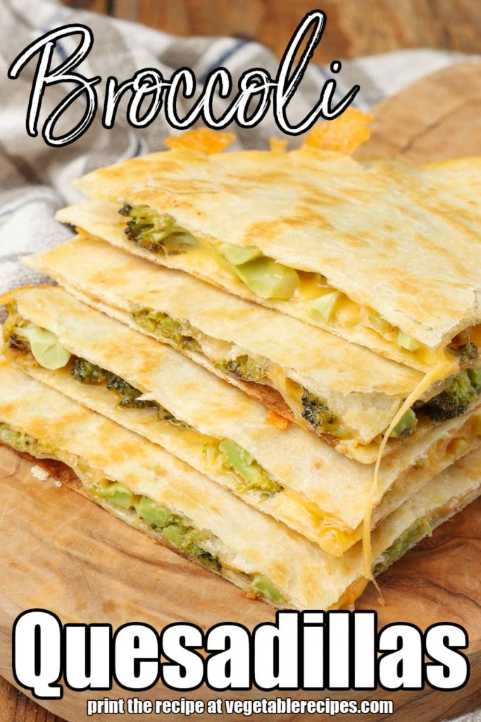 Vertical shot of quartered cheesy broccoli quesadillas stacked on top of one another, served on a cutting board