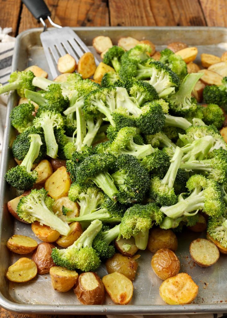 Broccoli and potatoes have been tossed with olive oil and spices.