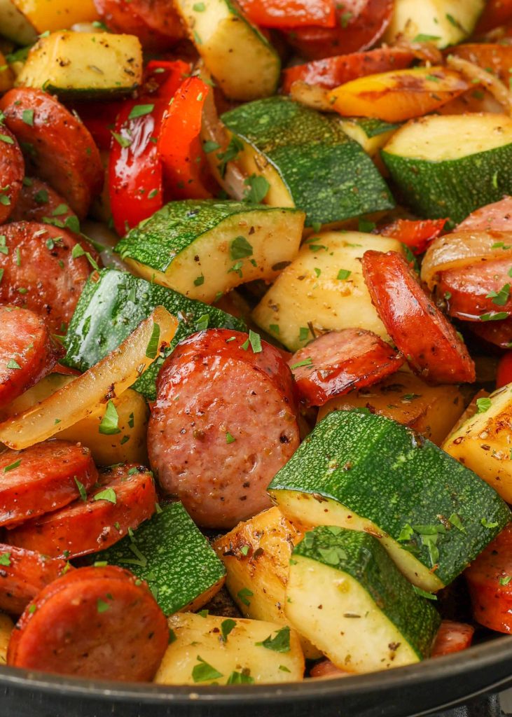 a close-up image of the vegetables and kielbasa in this sausage zucchini skillet.