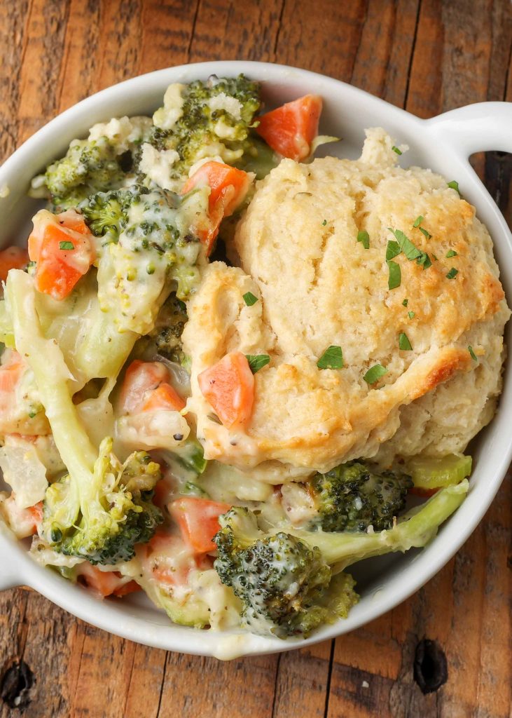 biscuit topped vegetable filled pot pie in round dish
