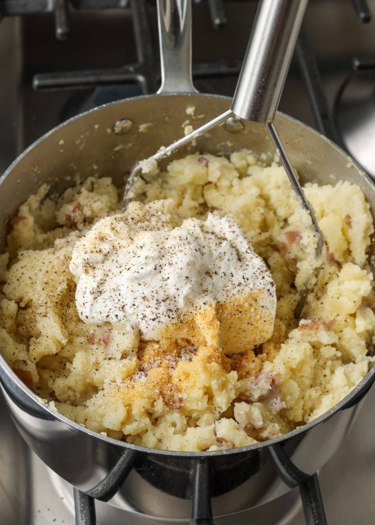 Overhead vertical shot of mashed potatoes cooking in a sauce pan