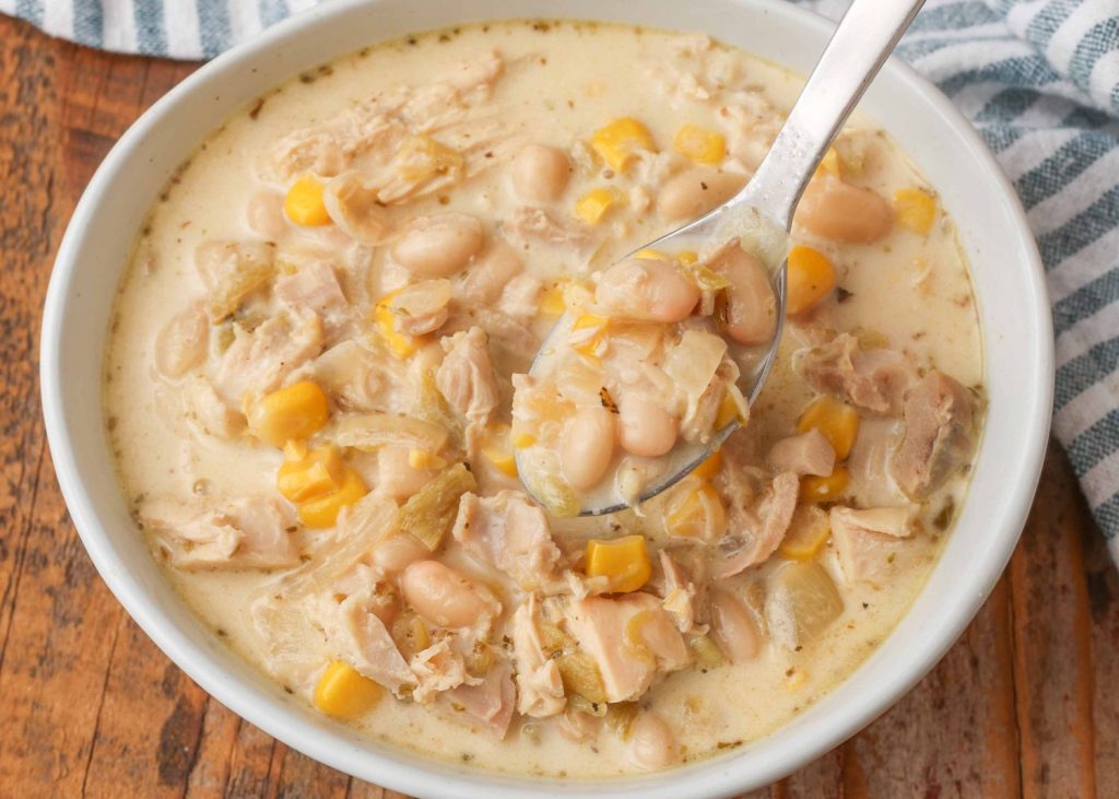 close up of spoon in bowl of white chicken chili