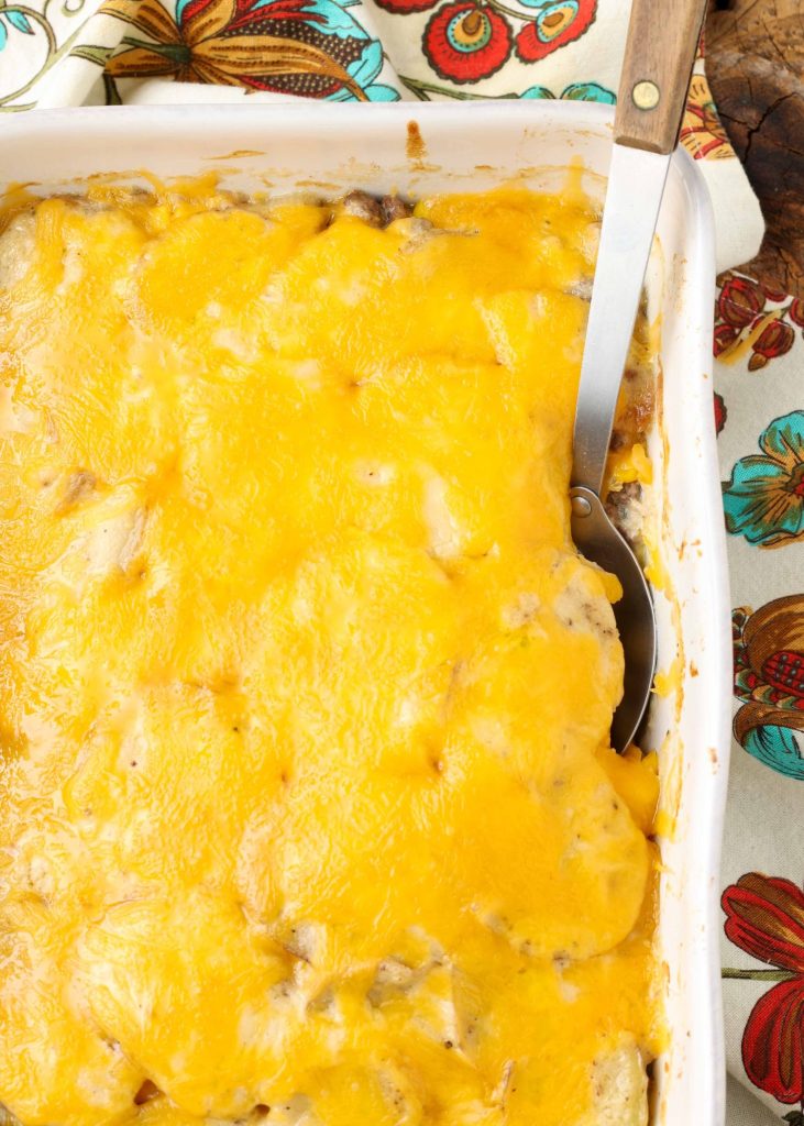 Overhead vertical shot of cheesy ground beef potato casserole in a long white tray