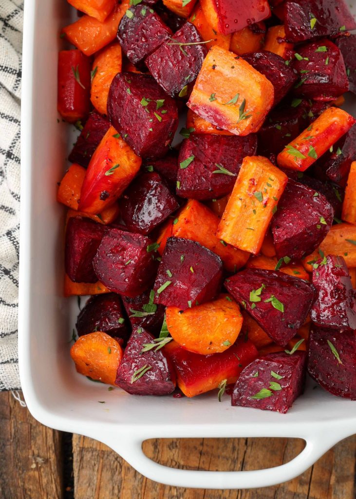 close up of roasted carrots and beets in white dish