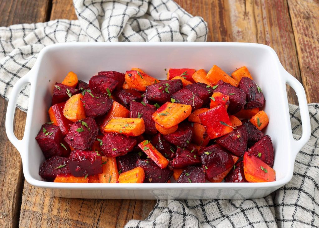 beets and carrots in white dish on wooden table