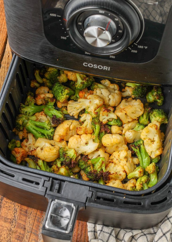 cooked broccoli and cauliflower in air fryer basket