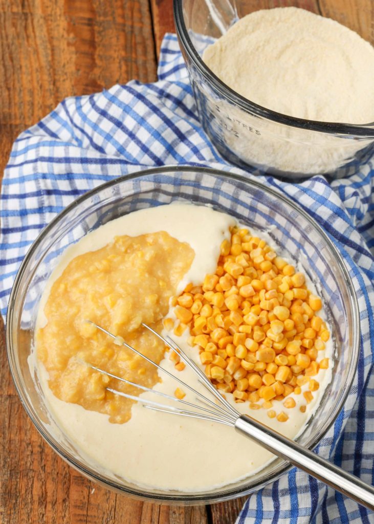 The creamed corn and frozen corn have been added to the other ingredients and are ready to combine.