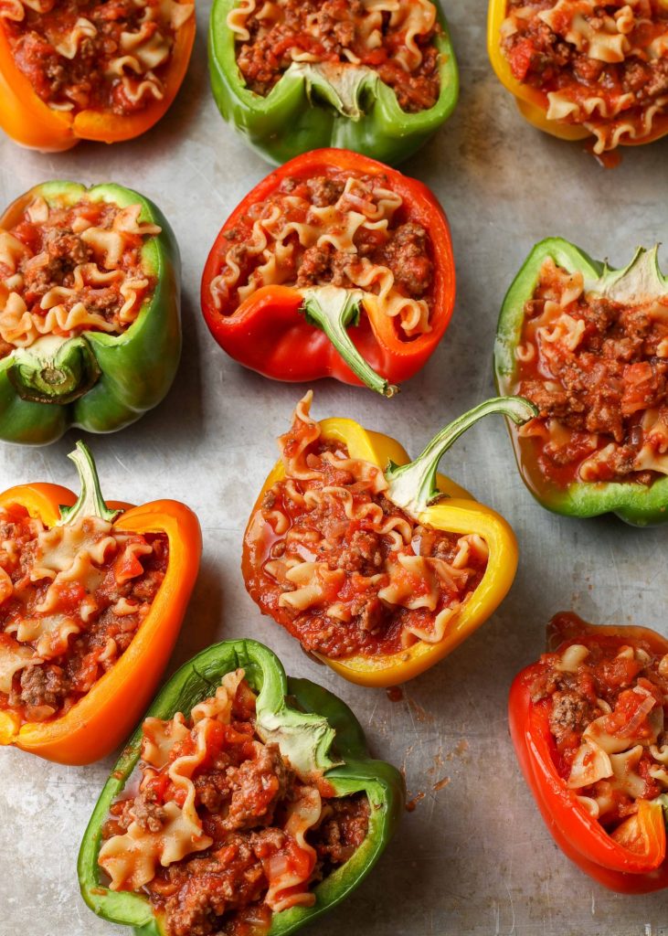 This photo features bell pepper halves that have been stuffed with pasta and meat sauce.