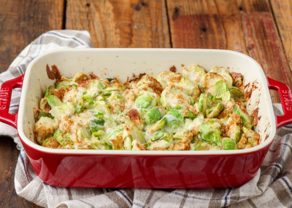 red casserole dish holding Brussels sprouts