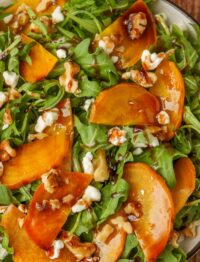 close up photo of arugula salad with gold beets and goat cheese