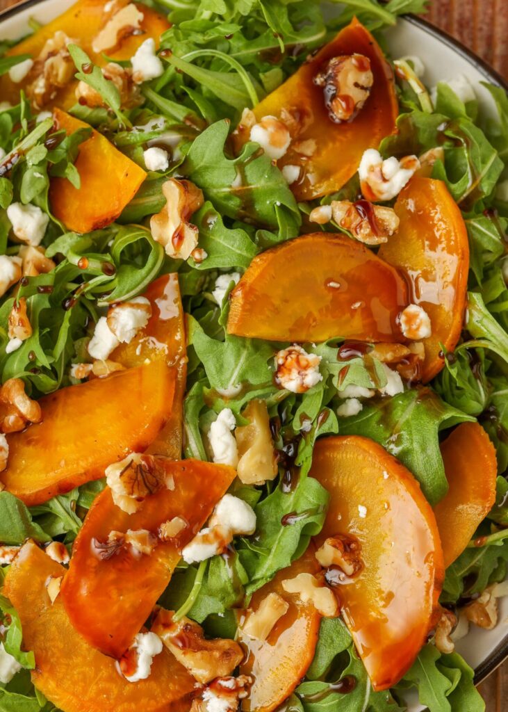 close up photo of arugula salad with gold beets and goat cheese