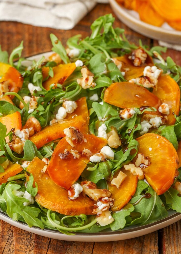overhead shot of salad with golden beets, arugula, goat cheese, walnuts, and balsamic glaze
