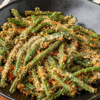 Close-up shot of Parmesan Green Beans served in a black bowl