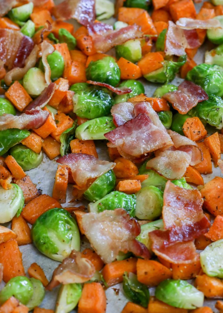 Close-up of sweet potatoes, Brussels sprouts, and bacon