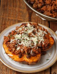 Taco Stuffed Sweet Potatoes topped with shredded cheese