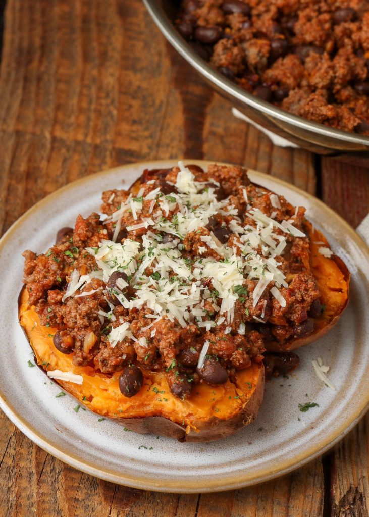 Taco Stuffed Sweet Potatoes topped with shredded cheese