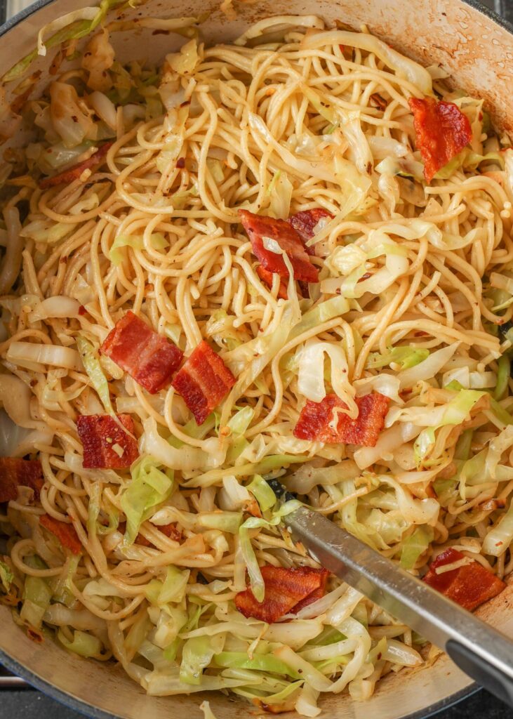 close up image of cabbage spaghetti in a pot.