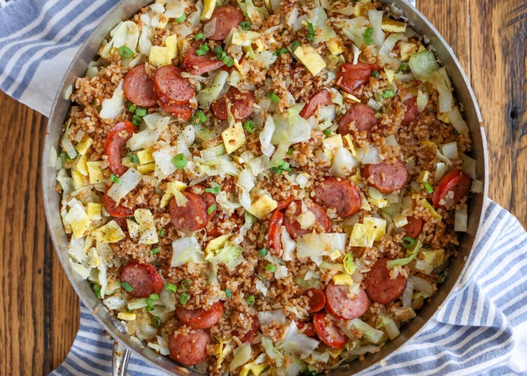 fried rice with cabbage and sausage in stainless pan