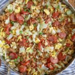 fried rice with cabbage and sausage in stainless pan