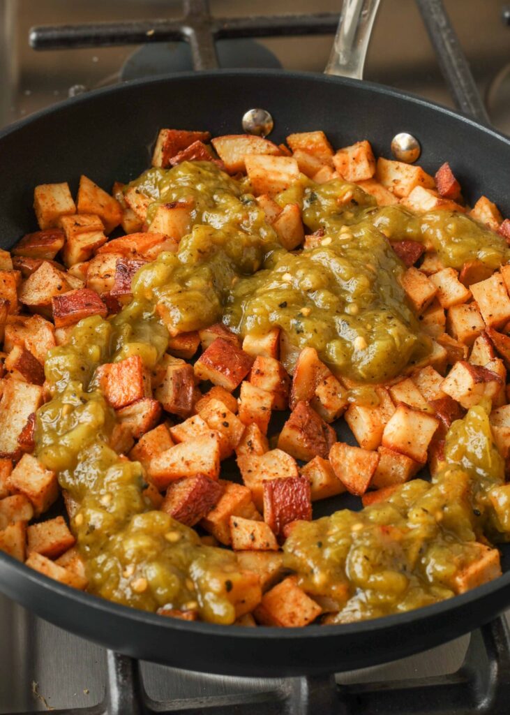 Adding green chile to potato skillet