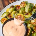 Brussels sprout on fork with bang bang sauce