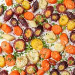 roasted Parmesan carrots with fresh herbs on baking sheet