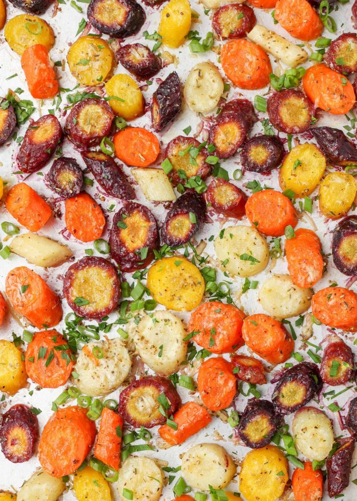 roasted Parmesan carrots with fresh herbs on baking sheet