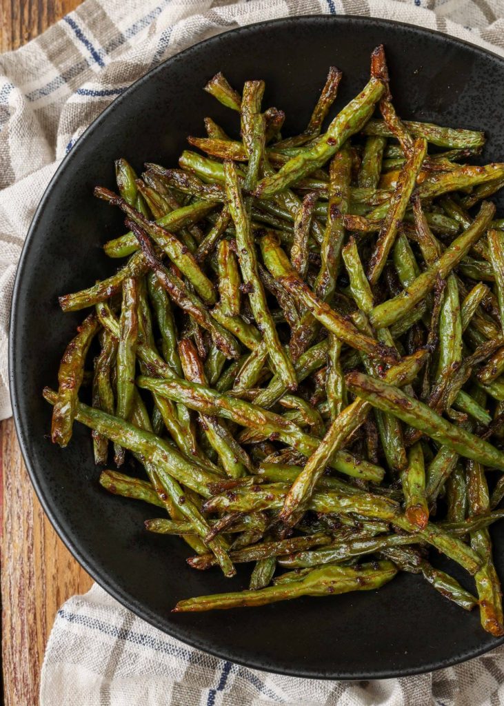 black serving bowl with roasted green beans