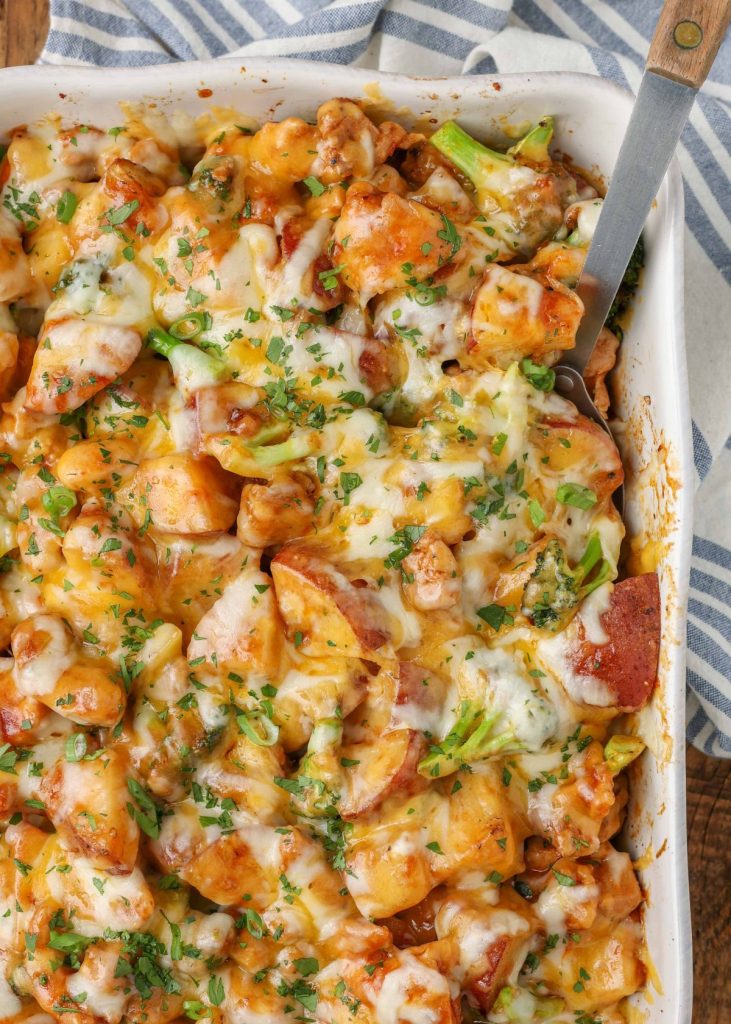 baking dish and serving spoon with chicken vegetable casserole