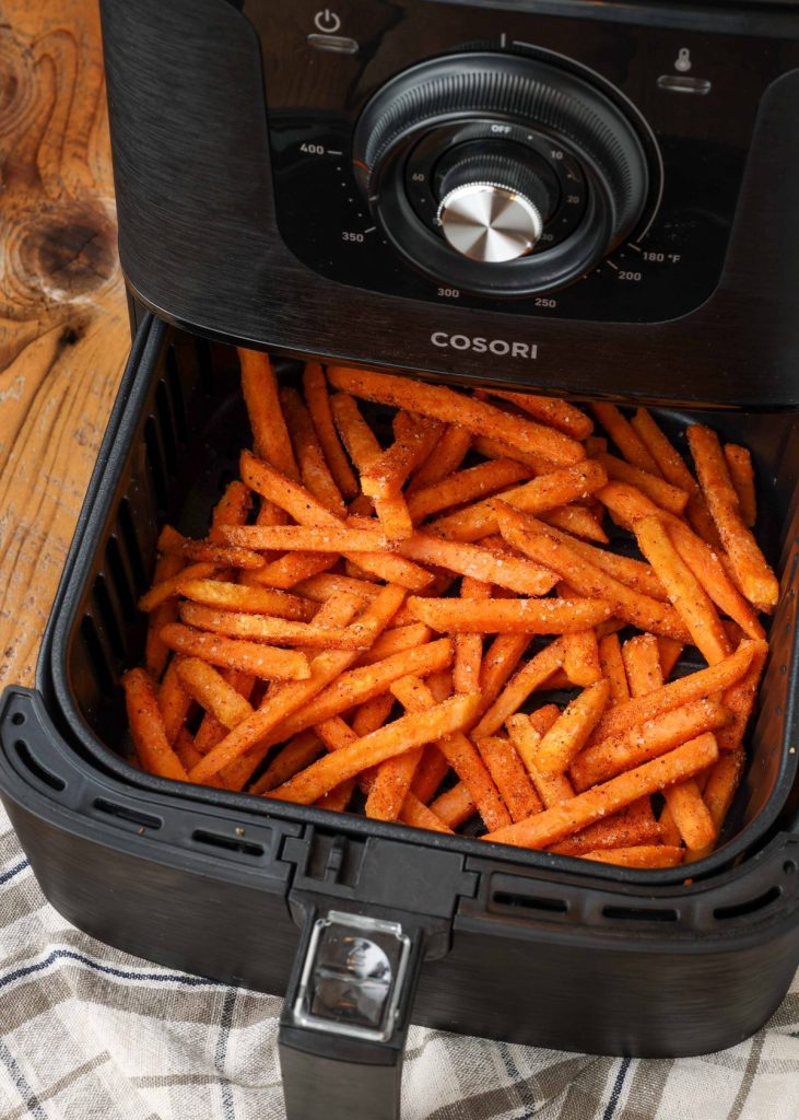 frozen fries in air fryer with plaid towel