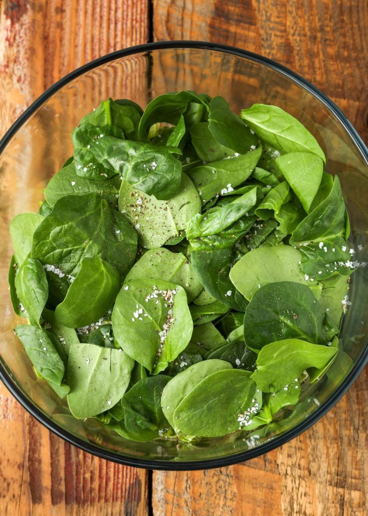 greens in bowl with salt and pepper