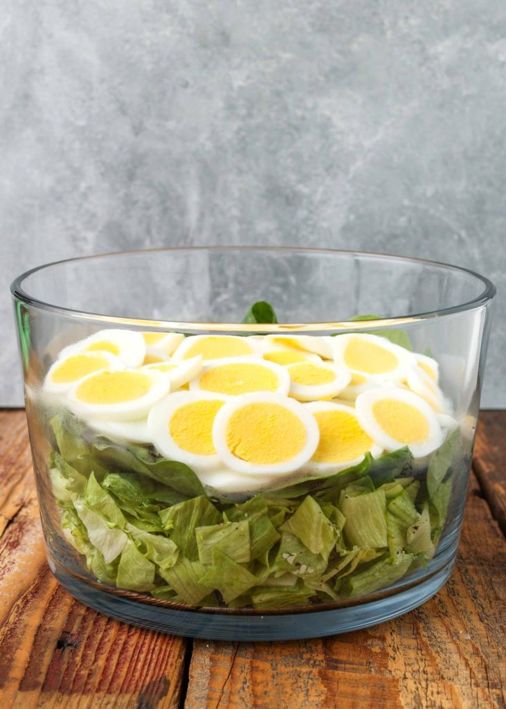 salad greens topped with hard boiled eggs