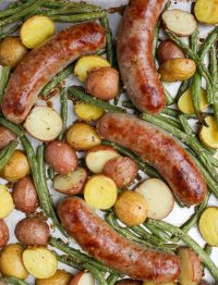 Oven Roasted Brats with Potatoes and Green Beans on metal pan