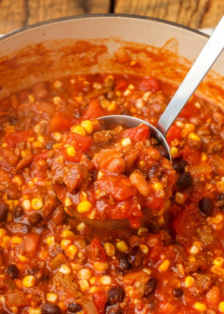 chili in ladle over large pot