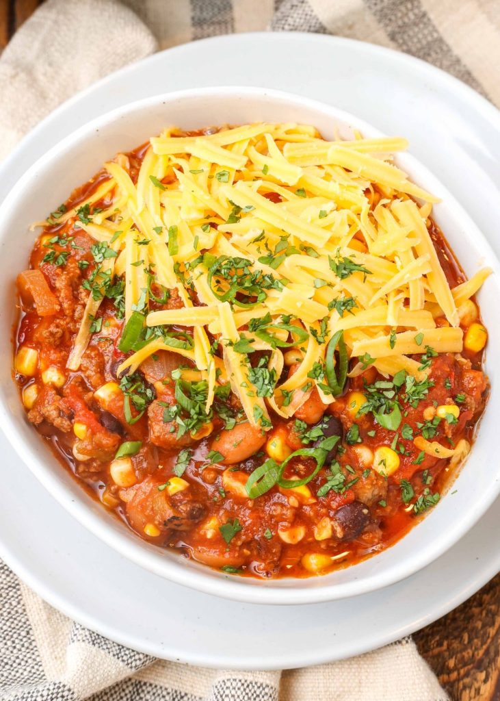 chili in bowl with cheddar cheese 