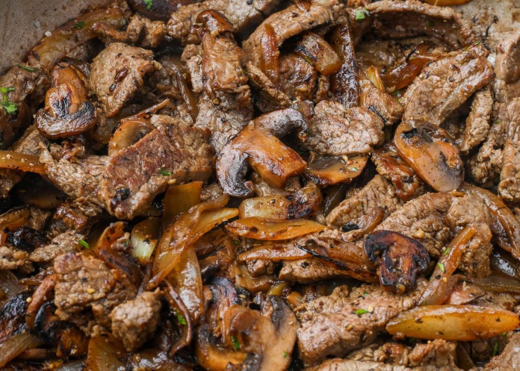stir fried steak mushrooms and onions in large skillet