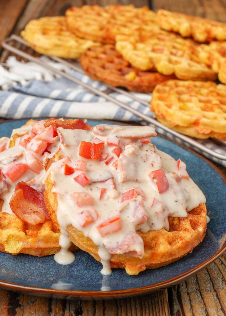 Red Pepper Bacon Gravy over corn waffles on wooden table