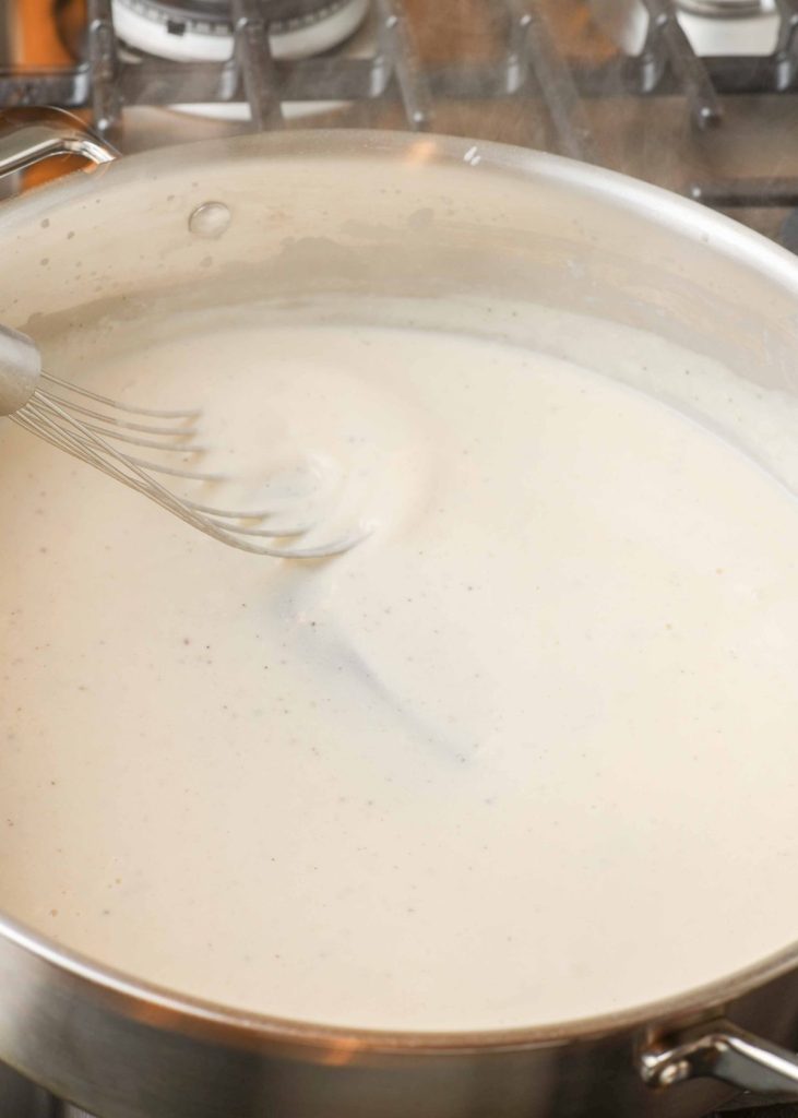 creamy sauce in skillet with whisk